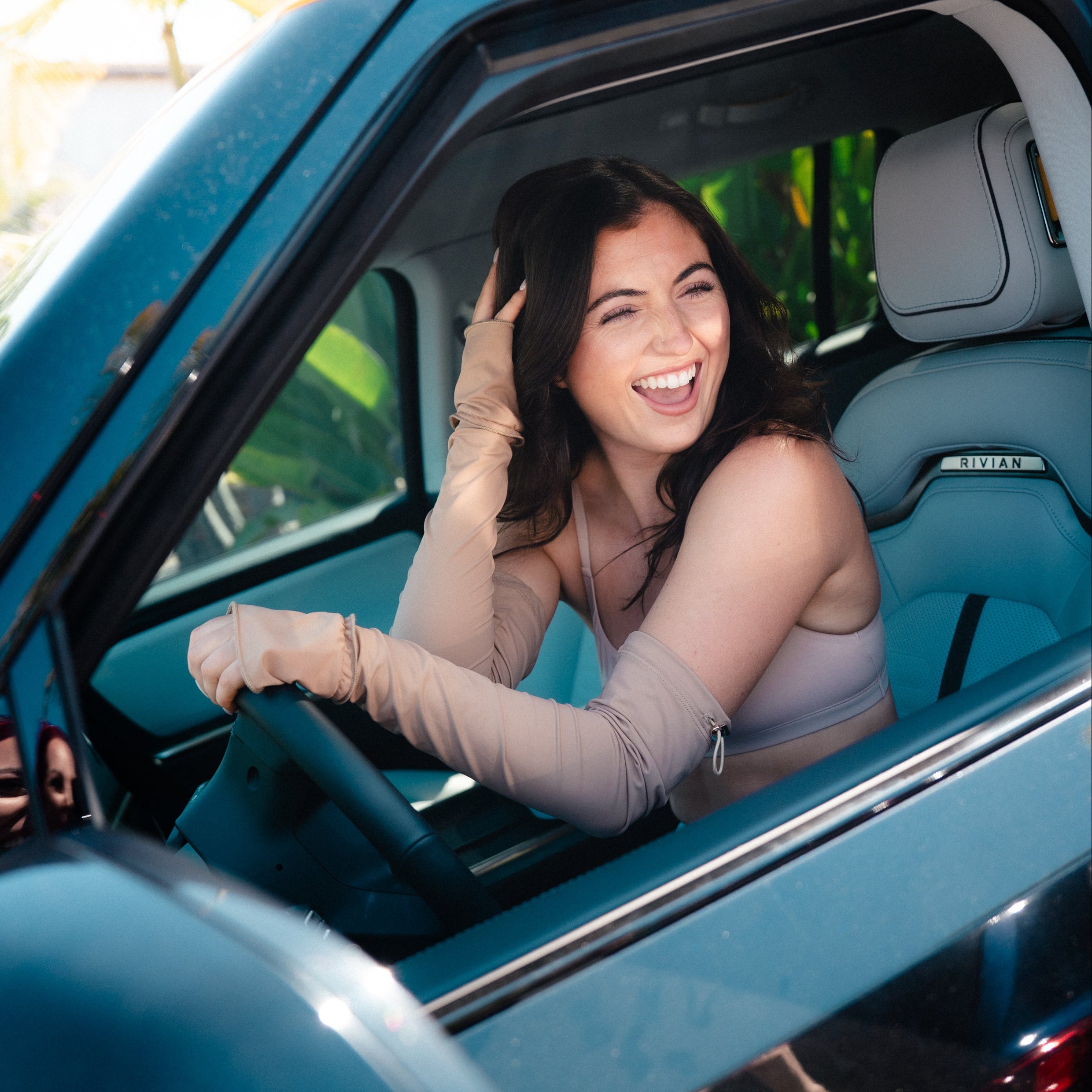 Woman sitting in a car with a blurred background