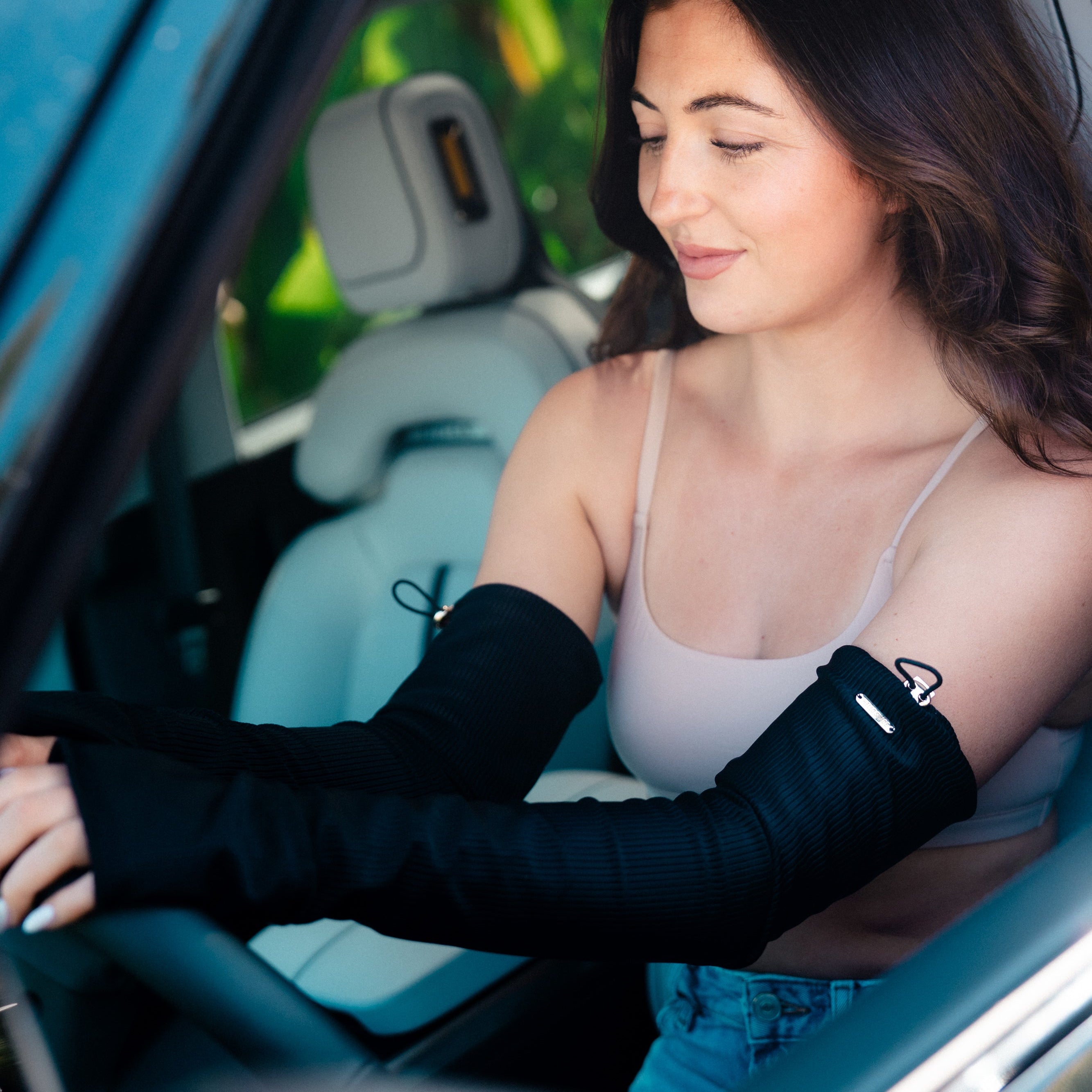 Woman sitting in a car with a blood pressure cuff on her arm