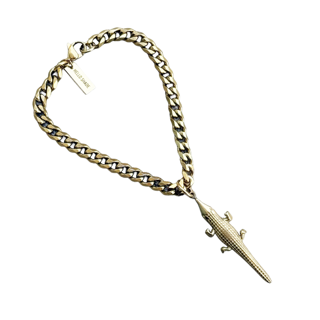 Gold chain with alligator clip on a white background